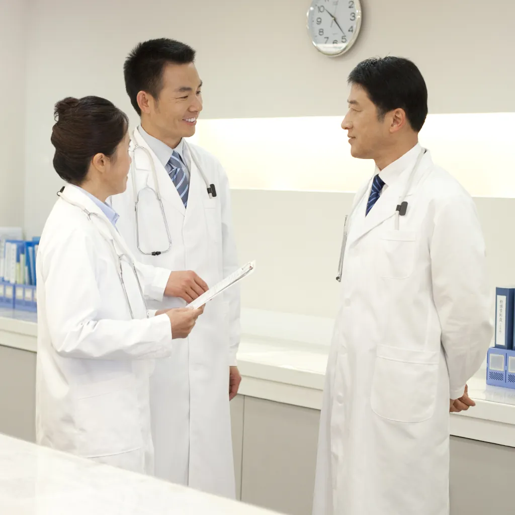 a-group-of-doctors-talking-behind-a-deask-2024-10-18-06-10-40-utc