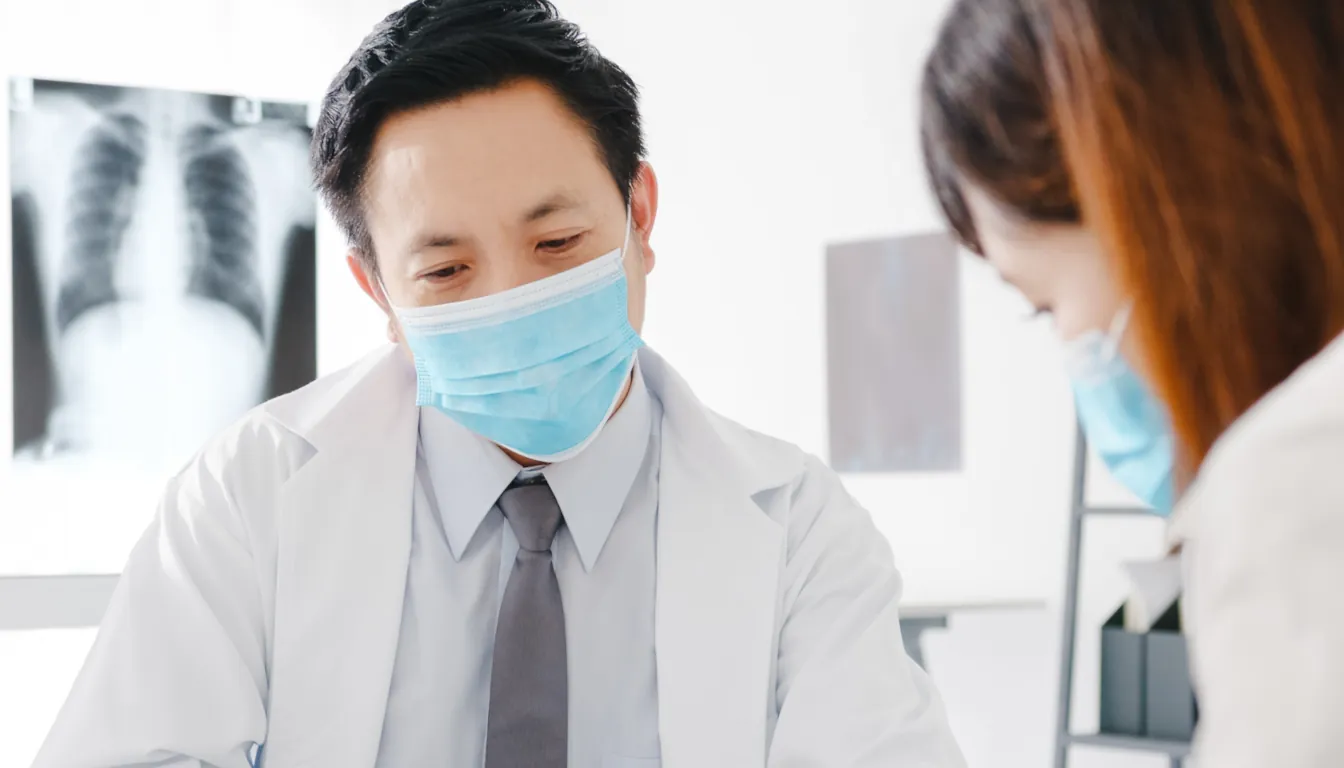 serious-asia-male-doctor-wear-protective-mask-talk-2024-11-02-13-15-13-utc
